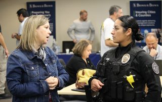 A police officer and a school district staff member connect at the safety summit