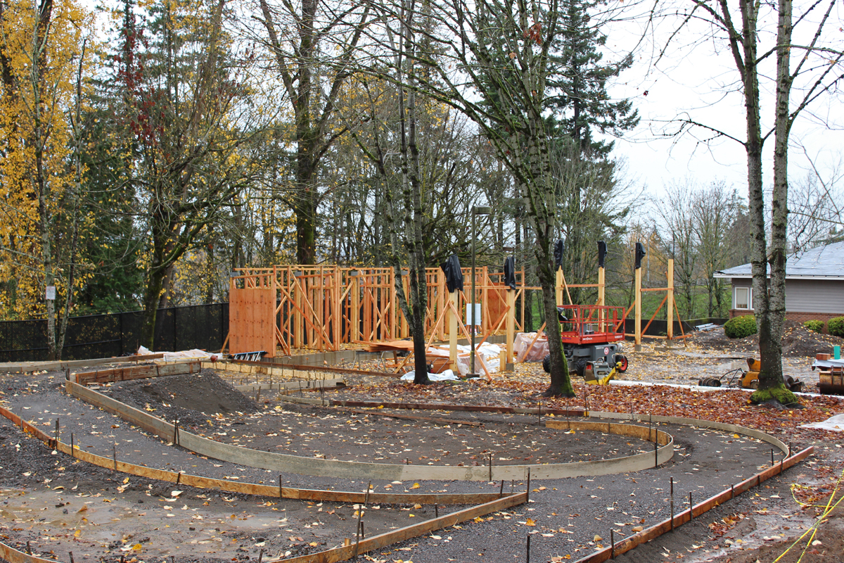 Site preparations for outdoor play spaces and framing for the covered outdoor play area at the new early learning center